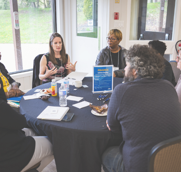A group of people talking around a table